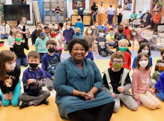 Photo from Stacey Abrams Twitter, were she can be seen as the only maskless person in the room - requiring all the young children to remain masked during COVID-19.