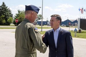 U.S. Rep. Jim Banks shakes hands with Col. Larry Shaw, 434th Air Refueling Wing commander, prior to touring Grissom Air Reserve Base, Ind., Aug. 23, 2017.