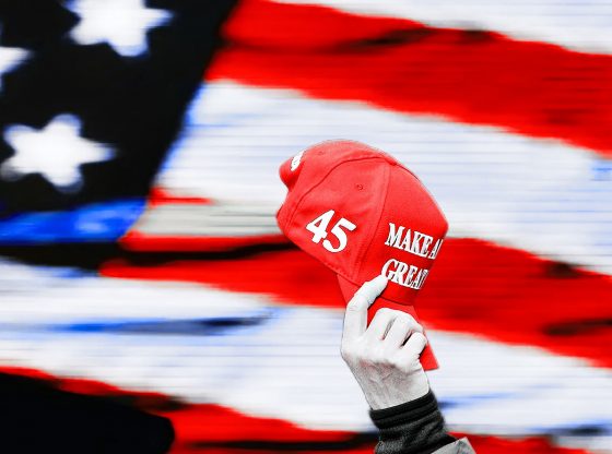 Photo edit of a Trump supporter holding a MAGA hat. Credit: Alexander J. Williams III/Popacta.