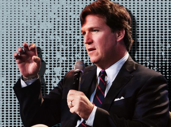 Tucker Carlson speaking at an event.